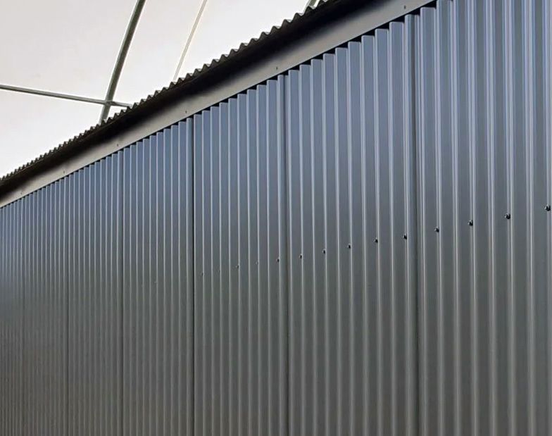 Corrugated profiled metal cladding