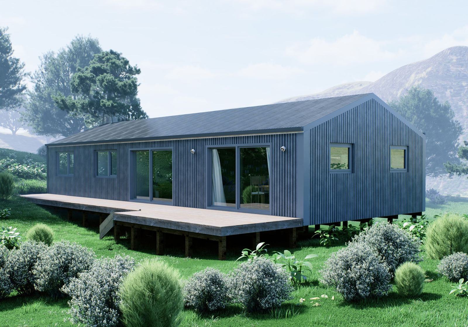 A dark-clad Smart Series home with a timber deck, set in a green garden with hills behind